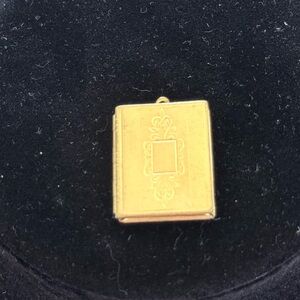 Gold tone book lock pedant